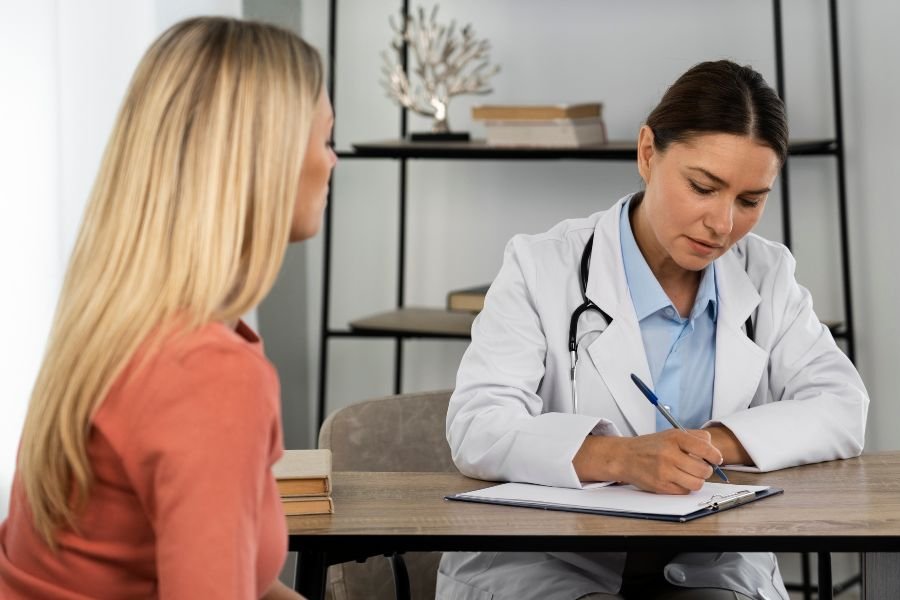 Médica preenchendo receita para paciente